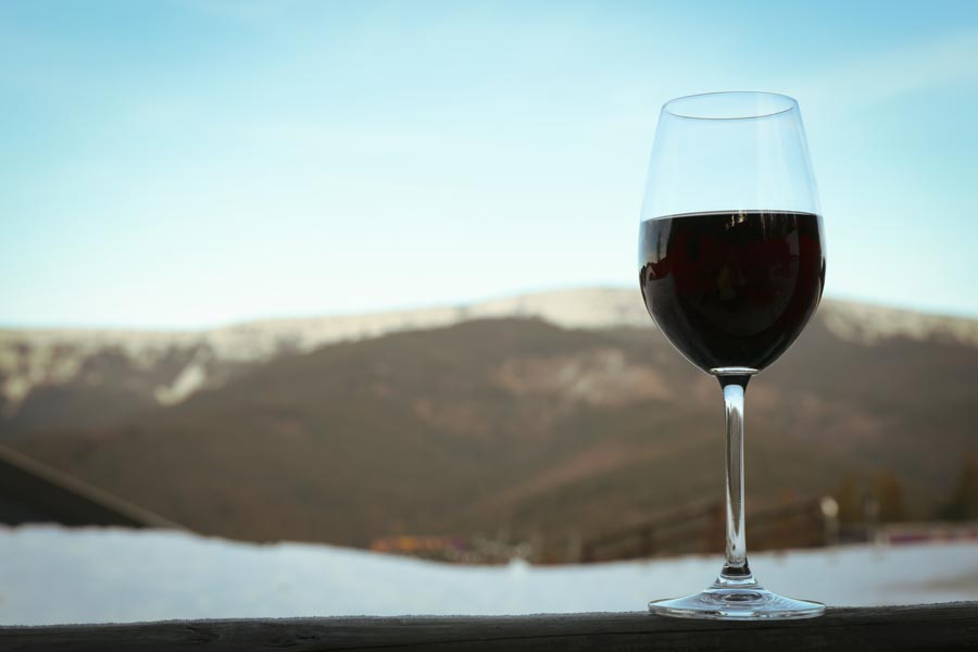 Glass of wine against mountains