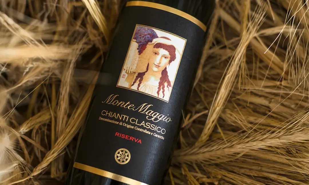 Bottle of Monte Maggio Chianti Classico Riserva wine on dry straw, with artistic label and elegant design 