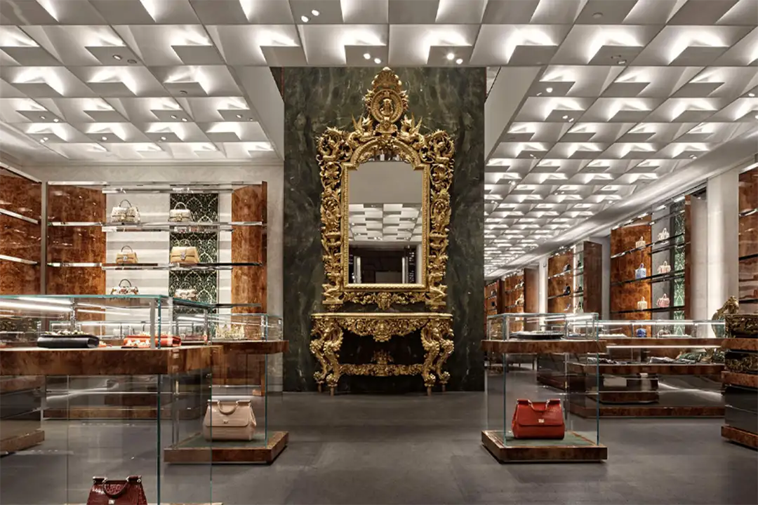 Luxurious Dolce & Gabbana store interior with handbags on display and a baroque mirror, capturing the essence of Italian fashion.
