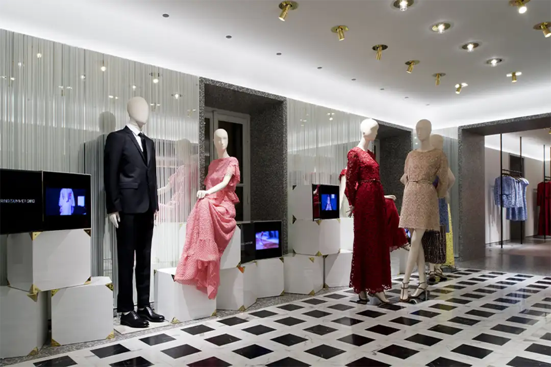 Valentino display featuring haute couture dresses in an elegant setting, celebrating the luxury of Italian fashion.
